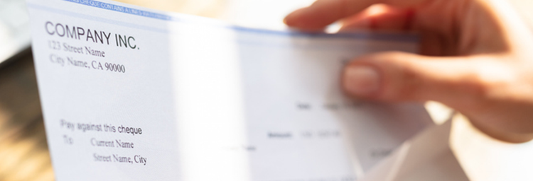 Compensation image for detail page, showing a paycheck being inserted into an envelope